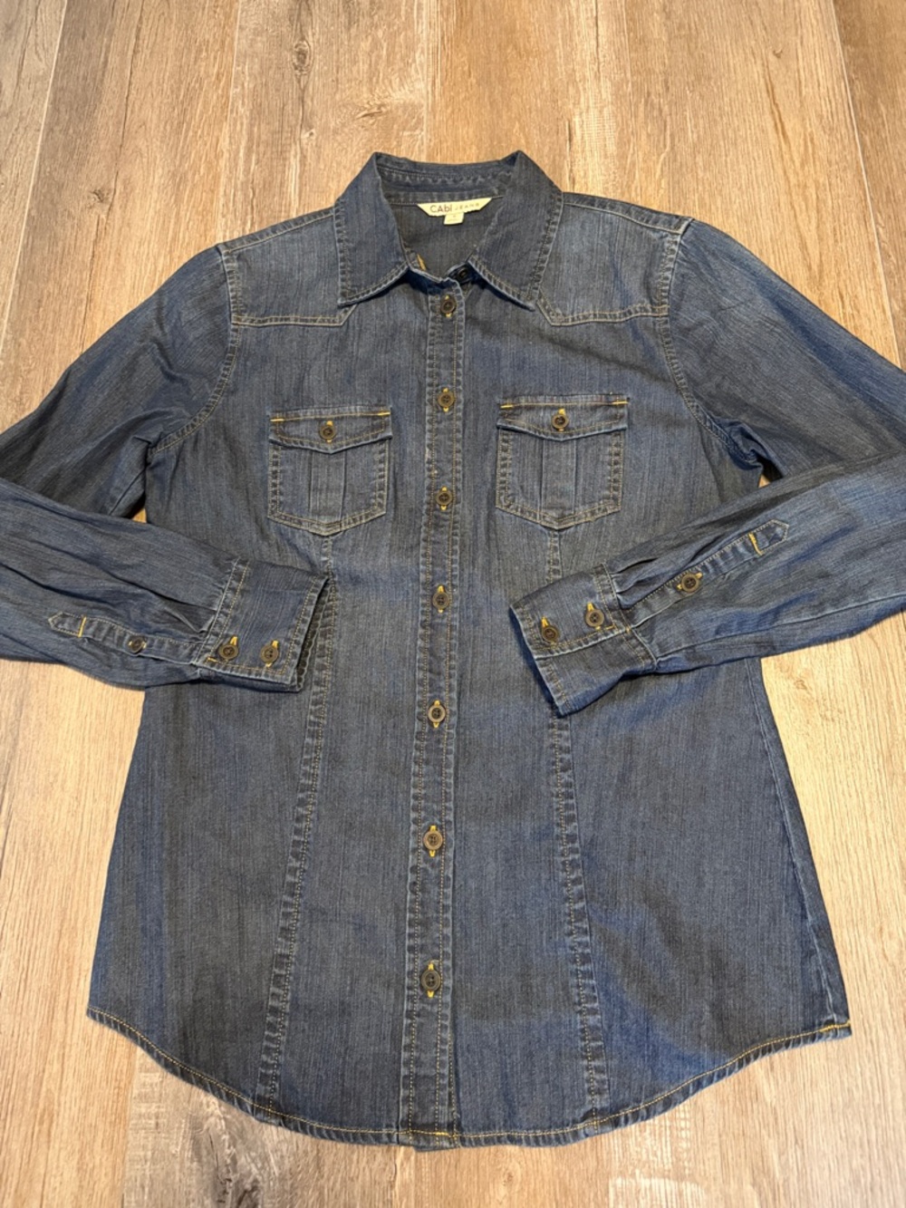 CAbi cotton denim button-down shirt featuring long sleeves with button cuffs.